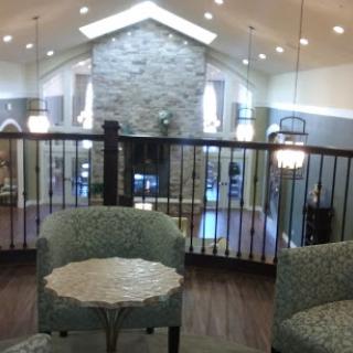 A stylish lobby featuring modern decor with a stone fireplace and comfortable seating.