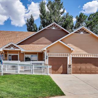 A charming single-story house with a well-maintained lawn and a two-car garage.