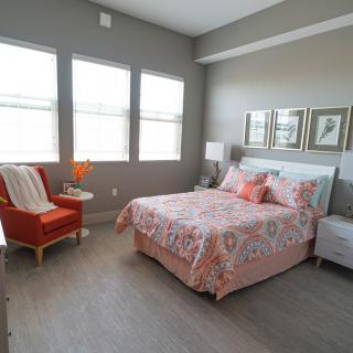 A cozy modern bedroom with stylish decor and ample natural light.