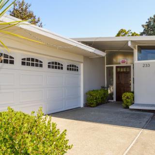 A modern suburban house with a two-car garage and a neatly maintained front yard.