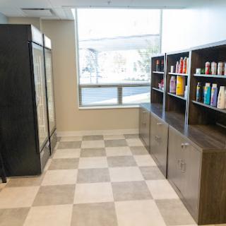 A well-organized room with shelves displaying various products and a large window providing natural light.