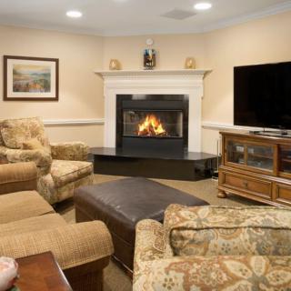 A cozy living room featuring a fireplace and comfortable seating arrangements.