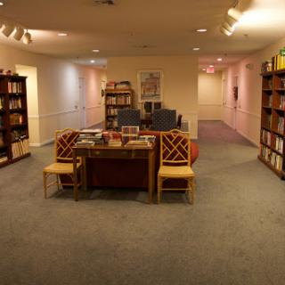 A cozy library space featuring bookshelves and comfortable seating.