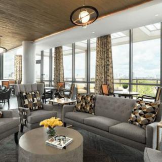A modern lounge area with comfortable seating and large windows allowing natural light.