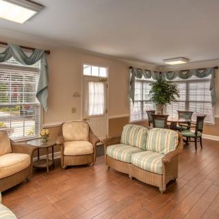 A cozy living room with comfortable seating, large windows, and elegant decor.