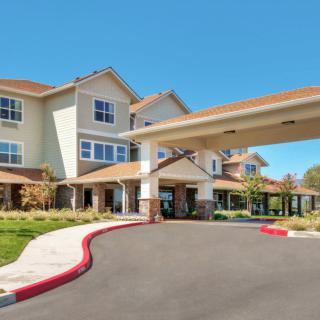A well-maintained building with an inviting entrance and landscaped surroundings.