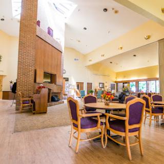 A spacious and inviting lobby area featuring modern furniture and a cozy fireplace.