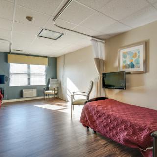 A bright and spacious hospital room designed for patient comfort.