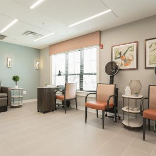 A modern waiting area with comfortable seating and artwork on the walls.