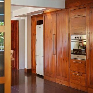 A modern kitchen with wooden cabinets and built-in appliances.