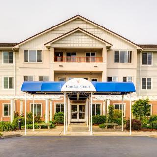 A three-story building with a blue awning at the entrance.