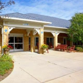 A welcoming entrance to a charming building with outdoor seating.