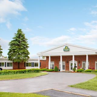 A welcoming hotel entrance surrounded by well-maintained landscaping.