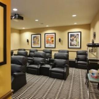 A cozy home theater room with comfortable seating and classic movie posters.