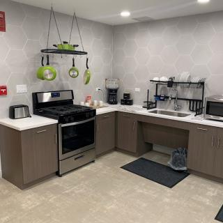A modern kitchen with stainless steel appliances and organized countertops.