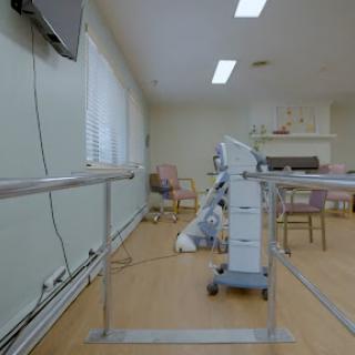 A physical therapy room featuring rehabilitation equipment and a wheelchair ramp.