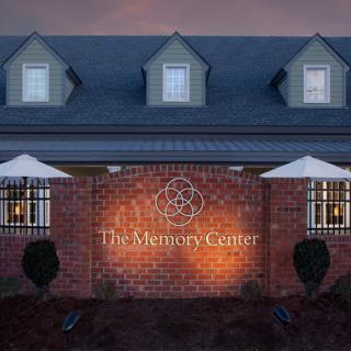The exterior of The Memory Center illuminated at night.