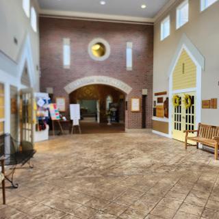 A spacious lobby featuring elegant architectural details and comfortable seating.