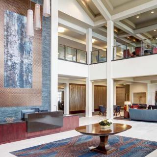 A modern and spacious hotel lobby with elegant interior design and decorative artwork.