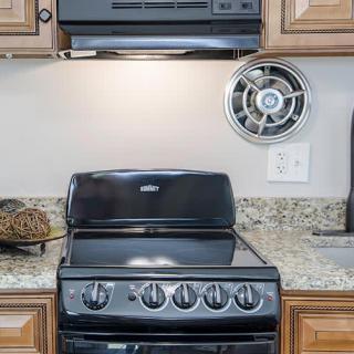 A modern kitchen with a black stove and granite countertop.