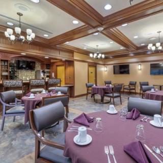 A well-decorated dining area with neatly arranged tables and chairs, ready for guests.