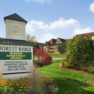 A scenic view of Forest Ridge senior apartment community surrounded by lush greenery.
