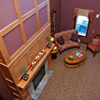 A cozy living room with a fireplace and comfortable seating area.
