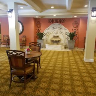A cozy lobby featuring a decorative fountain and comfortable seating.