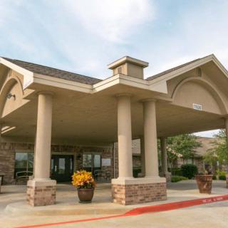 A building with a prominent entrance featuring large columns and an awning.