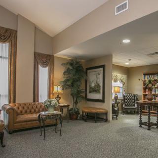 A traditional and cozy living room with elegant furnishings and warm lighting.