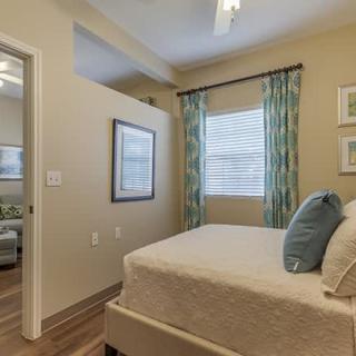 A modern bedroom with stylish decor and natural lighting.
