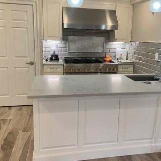 A modern kitchen with stainless steel appliances and a sleek countertop.