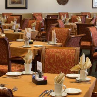 A restaurant's dining area with tables neatly set for service.