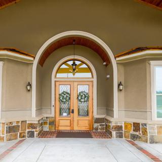 A welcoming front entrance with double doors and an arched design.