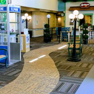 A view of a spacious indoor lobby featuring seating areas and decorative lighting.