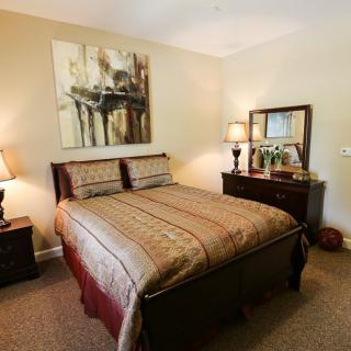 A cozy bedroom with a double bed, decorated with warm tones and elegant furnishings.