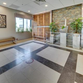 A contemporary lobby featuring a blend of natural elements and modern design.