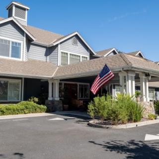 A residential building with an American flag displayed at the entrance.