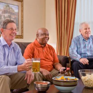 A group of friends enjoying drinks and snacks in a cozy living room.
