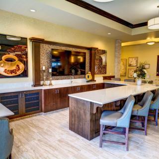 A modern kitchen interior with a large island counter and wooden cabinets.