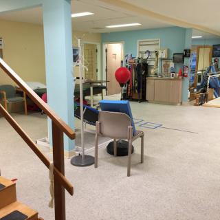 A rehabilitation center equipped with various physical therapy tools and exercise equipment.