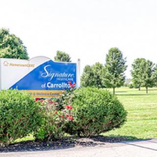 A sign for a nursing home facility surrounded by lush greenery.