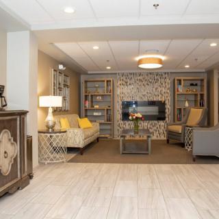 A modern living room with stylish decor, featuring a comfortable seating area and built-in bookshelves.