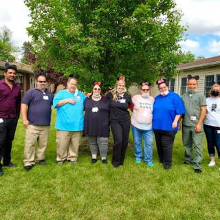 A friendly gathering outdoors, showcasing a diverse group of individuals enjoying their time together.