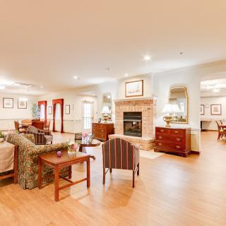 A spacious and cozy living room with elegant furnishings and a fireplace.