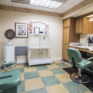 Interior view of a barber shop with chairs and salon equipment.