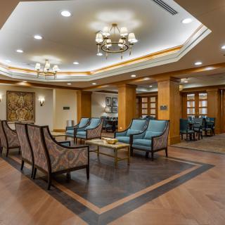 A modern lobby with comfortable seating and elegant chandeliers.