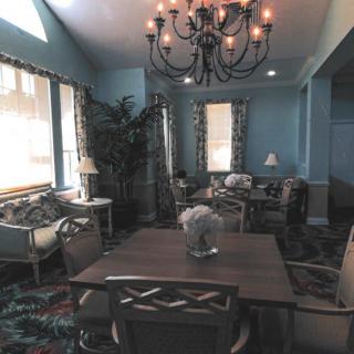 A cozy living room interior with elegant furniture and a chandelier.