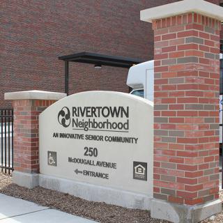 A sign at the entrance of Rivertown Neighborhood, an investing service community.