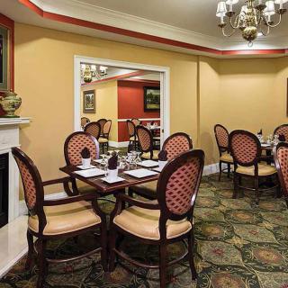 A classic and elegant dining room with neatly set tables and chairs.